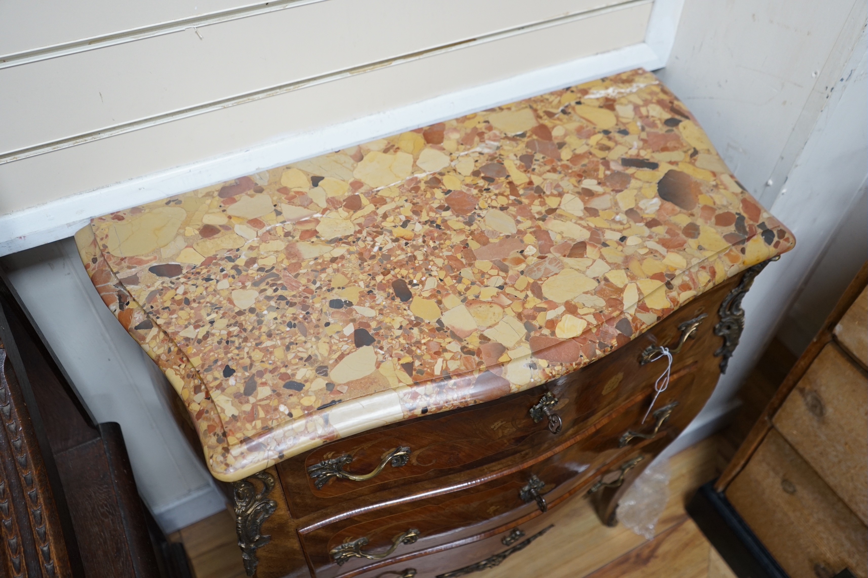 A Louis XV style marquetry inlaid marble topped serpentine three drawer commode, width 83cm, depth 40cm, height 87cm